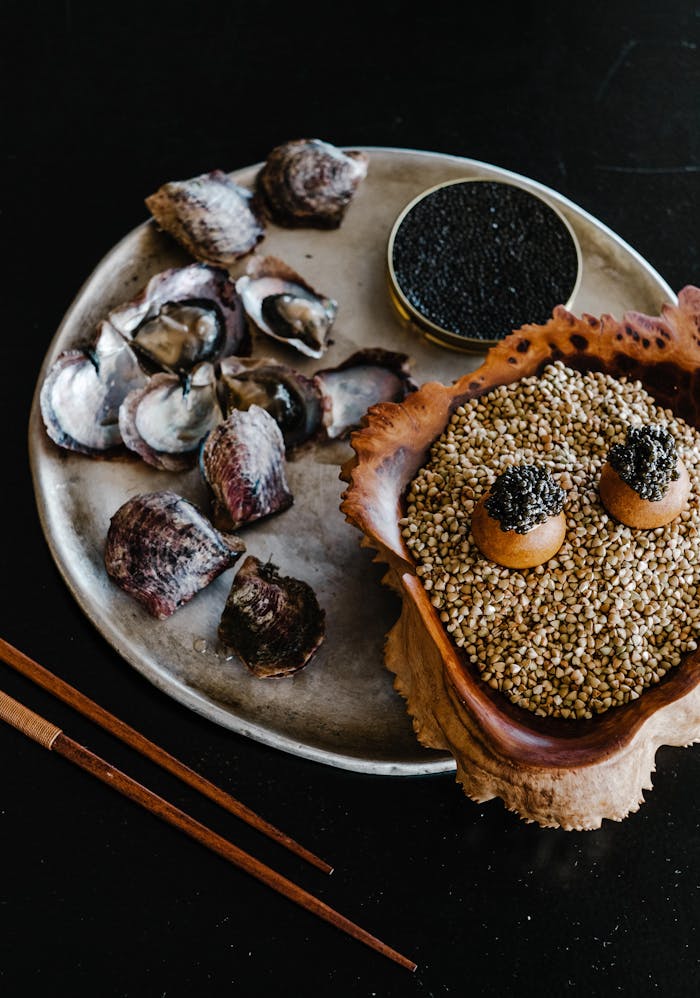 project-01-a Luxurious gourmet arrangement with seashells and caviar on a dark background.